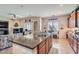 Open-concept kitchen with granite counters, wooden cabinets, and tile flooring throughout at 2345 Gondi Castle Ave, Henderson, NV 89044