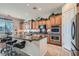 Kitchen featuring an island with seating, stainless steel appliances, and granite countertops at 2345 Gondi Castle Ave, Henderson, NV 89044
