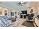 Spacious living room with large TV, a ceiling fan, neutral paint, and lots of natural light at 2345 Gondi Castle Ave, Henderson, NV 89044