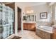 Bright bathroom featuring a soaking tub, shower, and wood cabinets at 2345 Gondi Castle Ave, Henderson, NV 89044