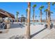 Palm tree-lined pool area surrounded by lounge chairs and tables at 2404 Elmont Ave, North Las Vegas, NV 89086