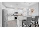 Modern kitchen with stainless steel appliances, white cabinetry, granite countertops and eat in bar stool seating at 2404 Elmont Ave, North Las Vegas, NV 89086