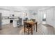 An open-concept kitchen with stainless steel appliances, a granite countertop island, and eat-in bar stool seating at 2404 Elmont Ave, North Las Vegas, NV 89086