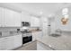 Updated kitchen featuring stainless steel appliances, granite countertops, white cabinetry and a modern design at 2404 Elmont Ave, North Las Vegas, NV 89086