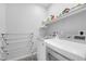Laundry room featuring updated appliances and a drying rack at 2404 Elmont Ave, North Las Vegas, NV 89086
