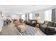 Open-concept living room with hardwood floors, neutral decor, and seamless flow to the dining area at 2404 Elmont Ave, North Las Vegas, NV 89086
