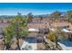 Aerial view of a residential home featuring a concrete driveway, mature trees, and xeriscaping at 2517 Desert Glen Dr, Las Vegas, NV 89134