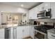 Well-lit kitchen with stainless steel appliances, granite countertops, and an open view to the dining area at 2517 Desert Glen Dr, Las Vegas, NV 89134