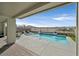 Backyard featuring a private pool, covered patio, seating, and scenic views of the surrounding landscape at 2587 Tolmezzo St, Henderson, NV 89044