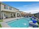Backyard with a private pool, covered patio, seating, and barbecue grill perfect for entertaining guests at 2587 Tolmezzo St, Henderson, NV 89044