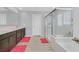 Modern bathroom with double vanity, spacious shower, and soaking tub at 2587 Tolmezzo St, Henderson, NV 89044