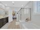 Bathroom featuring a glass enclosed shower and a double vanity sink at 2587 Tolmezzo St, Henderson, NV 89044