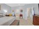 Bedroom featuring wood-look flooring, a tufted bench, and an ensuite bathroom at 2587 Tolmezzo St, Henderson, NV 89044