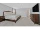 Spacious primary bedroom featuring plush carpeting, a large bed, and a mounted TV at 2587 Tolmezzo St, Henderson, NV 89044