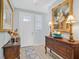 Elegant entryway featuring a wooden console table adorned with lamps and decorative items at 2587 Tolmezzo St, Henderson, NV 89044