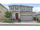 Charming two-story home with a well-manicured lawn and a brick driveway leading to a two-car garage at 2587 Tolmezzo St, Henderson, NV 89044