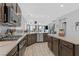 Well-lit kitchen featuring stainless steel appliances, a center island, and open access to the living areas at 2587 Tolmezzo St, Henderson, NV 89044
