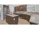 Modern kitchen with stainless steel appliances, a center island, and stylish backsplash at 2587 Tolmezzo St, Henderson, NV 89044
