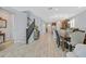 Open floor plan showcasing the staircase, kitchen, and dining areas with wood-look tile flooring at 2587 Tolmezzo St, Henderson, NV 89044