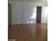 Bedroom featuring a closet with sliding doors and light wood laminate floors at 3435 Villa Knolls South Dr, Las Vegas, NV 89120
