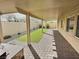 Covered backyard patio features a brick surface and low maintenance artificial turf at 3581 Rio Paloma Ct, North Las Vegas, NV 89031