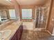 Spacious bathroom with a dual sink vanity, walk-in shower, and soaking tub by a sunny window at 3581 Rio Paloma Ct, North Las Vegas, NV 89031