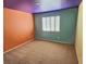 Spacious bedroom featuring multi-colored walls, plush carpet, and bright shuttered window for natural light at 3581 Rio Paloma Ct, North Las Vegas, NV 89031