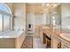 Bright bathroom featuring double sinks, bathtub, shower and tiled floors, creating a clean and functional space at 4033 Bliss Canyon Ct, Las Vegas, NV 89129
