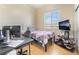 Bedroom featuring a single bed, work station, and a window, creating a comfortable and functional space at 4033 Bliss Canyon Ct, Las Vegas, NV 89129