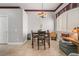Bright dining room with a wooden table set, window with blinds, and neutral walls at 4033 Bliss Canyon Ct, Las Vegas, NV 89129