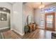 Inviting foyer with hardwood floors, decorative mirror, and elegant lighting fixture at 4033 Bliss Canyon Ct, Las Vegas, NV 89129
