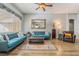 Bright living room with hard wood flooring, light blue sofa and a large window at 4033 Bliss Canyon Ct, Las Vegas, NV 89129
