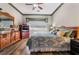 Inviting main bedroom featuring wood floors, neutral walls, and a large window at 4033 Bliss Canyon Ct, Las Vegas, NV 89129