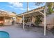 Covered outdoor patio with seating area overlooking the pool and landscaped backyard at 4033 Bliss Canyon Ct, Las Vegas, NV 89129