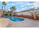Refreshing swimming pool with concrete patio, pergola, and manicured tropical backyard landscaping at 4033 Bliss Canyon Ct, Las Vegas, NV 89129