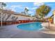 Backyard view of the refreshing swimming pool with concrete patio and minimal tropical landscaping at 4033 Bliss Canyon Ct, Las Vegas, NV 89129