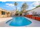 Backyard view of the refreshing swimming pool with concrete patio, pergola, and tropical landscaping at 4033 Bliss Canyon Ct, Las Vegas, NV 89129
