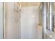 Bright shower with white tiles, a chrome shower head and clear glass doors, providing a clean and modern feel at 4033 Bliss Canyon Ct, Las Vegas, NV 89129
