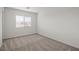 Comfortable bedroom featuring a large window, neutral carpeting, and ample natural light at 4224 Golden Sol St, North Las Vegas, NV 89032
