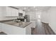 Modern kitchen with stainless steel appliances, center island, and stylish gray countertops and wood floors at 4224 Golden Sol St, North Las Vegas, NV 89032