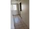 Hallway featuring neutral tile flooring leading to an exterior exit door at 4231 White Sands Ave, Las Vegas, NV 89121