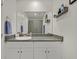 Bright bathroom with a granite countertop, white cabinets, and a large mirror at 527 Clearsable Ave, Henderson, NV 89044