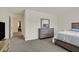 Bedroom showcasing neutral walls, gray carpet, a dresser, white bedspread, and a doorway to another room at 527 Clearsable Ave, Henderson, NV 89044