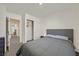 Neutral bedroom with gray upholstered bed, closet with sliding doors, and light-colored walls at 527 Clearsable Ave, Henderson, NV 89044
