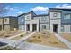 Modern townhome showcasing a gray facade, complemented by rock landscaping, a concrete walkway, and a blue sky backdrop at 527 Clearsable Ave, Henderson, NV 89044