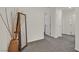 Neutral hallway with gray carpeting, white walls, and doorways leading to various rooms in the house at 527 Clearsable Ave, Henderson, NV 89044