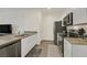 The kitchen features white cabinets, granite countertops, stainless steel appliances, and a view into the living area at 527 Clearsable Ave, Henderson, NV 89044