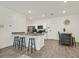 Eat-in kitchen features wood floors, white cabinets, granite countertops, stainless steel appliances, recessed lighting, and breakfast bar seating at 527 Clearsable Ave, Henderson, NV 89044