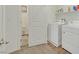 Modern laundry room with a white washer and dryer and a door to the toilet at 527 Clearsable Ave, Henderson, NV 89044