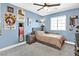 Bedroom with blue walls, ceiling fan, and Vegas Golden Knights décor at 625 Honesty Ct, Henderson, NV 89011